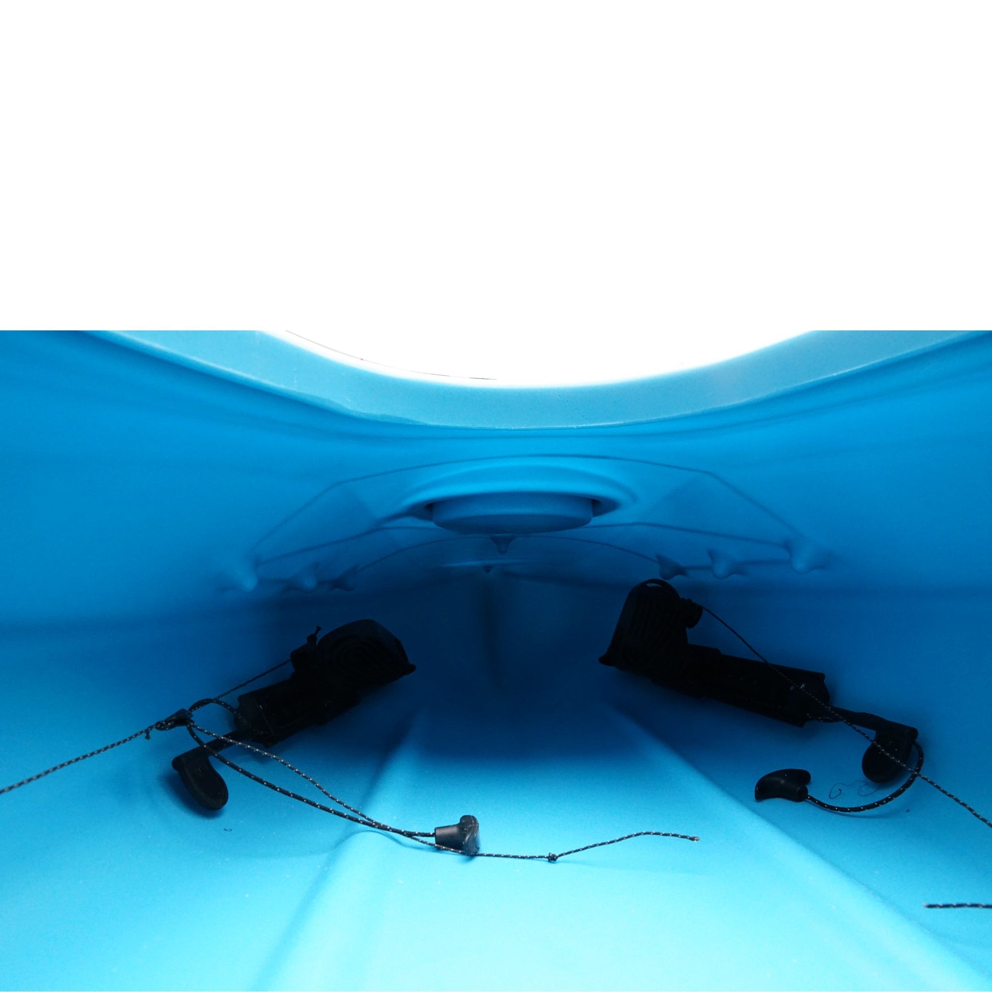 Cockpit view of the Cambridge Kayaks touring kayak in light blue, showing padded seat, hatch opening, and deck lines.