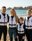 Family wearing Baltic Aqua Pro buoyancy aids on a beach ready for kayaking