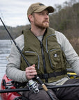 Close view of Baltic Outdoor camo green buoyancy aid showing zipped storage pockets, front zip fastening, and adjustable waist belt worn by kayak fisherman