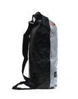 Side view of the Cambridge Kayaks 10 Litre Dry Bag in grey showing the adjustable carry strap and secure roll-top buckle system for easy transport and watertight protection.