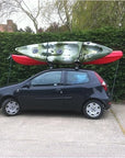Cambridge Kayaks 1st Edition Folding J Bars carrying kayak securely on car roof, demonstrating real-world use.