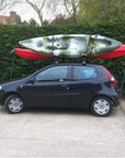 Cambridge Kayaks 1st Edition Folding J Bars carrying kayak securely on car roof, demonstrating real-world use.