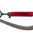 Cambridge Kayaks manual bilge pump in red with attached grey flexible drainage hose, designed for kayak water removal.