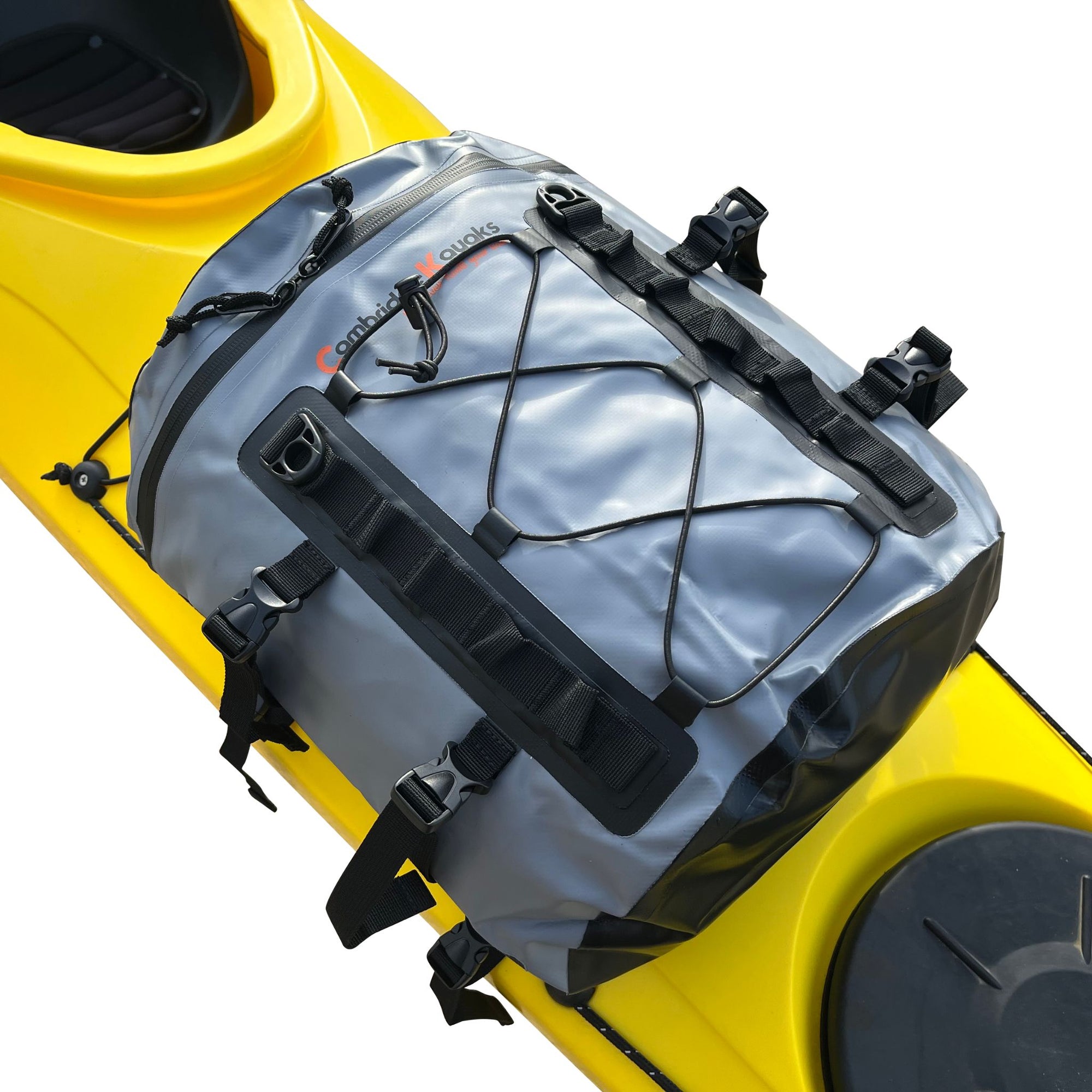 The Cambridge Kayaks Deluxe 15L Dry Deck Bag securely mounted on a yellow kayak, showing how it attaches using adjustable clips and straps for on-deck waterproof storage.