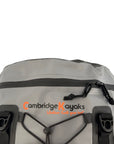 Top angle of the Cambridge Kayaks Deluxe 15L Dry Deck Bag displaying the logo, roll-top buckle system, and elastic storage cord for convenient on-water gear access.