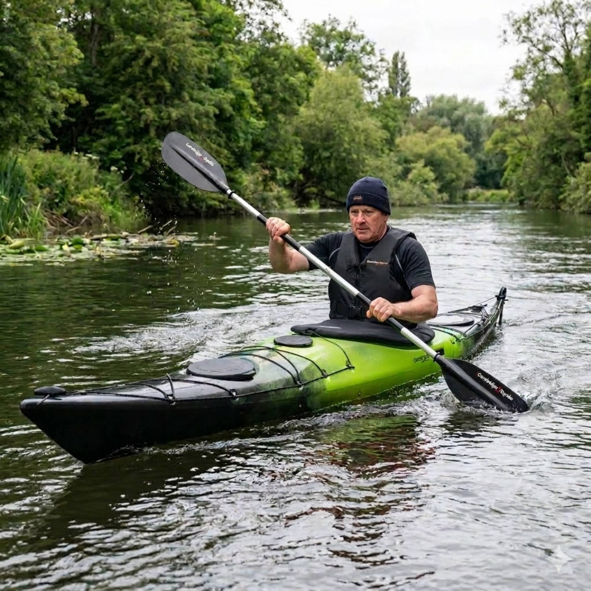Man paddling Cambridge Kayaks Explorer 430 sit inside touring kayak on a calm river
