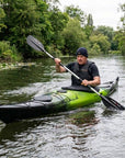 Man paddling Cambridge Kayaks Explorer 430 sit inside touring kayak on a calm river
