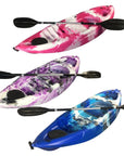 Cambridge Kayaks Guppy sit-on-top kayaks for kids shown in multiple colours including pink, blue, and purple, each with paddle — compact, stable, and ideal for young paddlers on lakes, rivers, and calm seas.