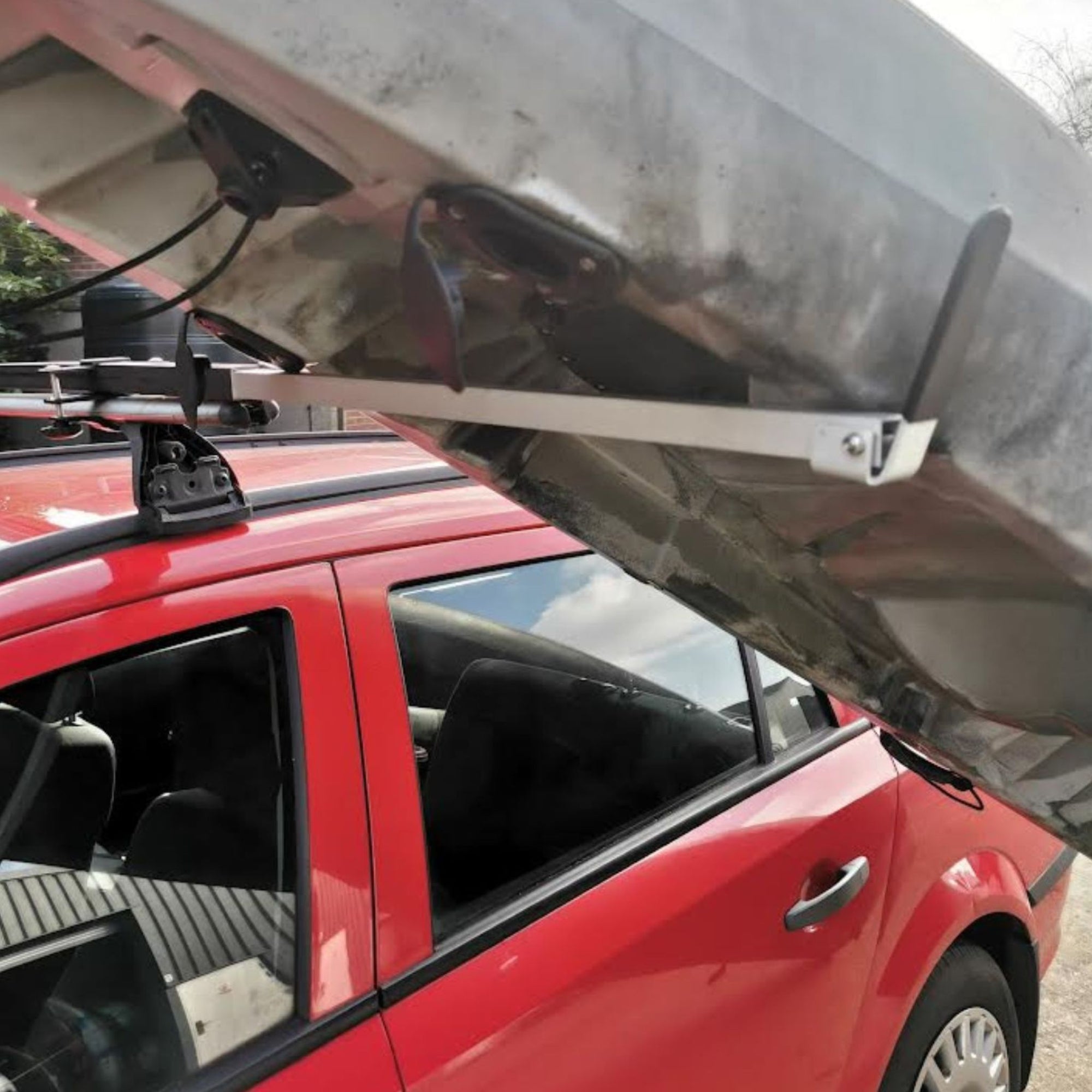 Cambridge Kayaks Load Assisting Rack Bar shown mid-use, demonstrating how it supports kayak lifting at an angle for safe placement onto the roof rack.