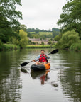 Man paddling Cambridge Kayaks Neptune single sit on top kayak on a calm river front view