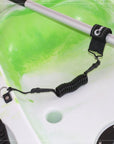Close-up of Cambridge Kayaks paddle leash connected to a kayak paddle and deck mount, showing secure coiled design in use.