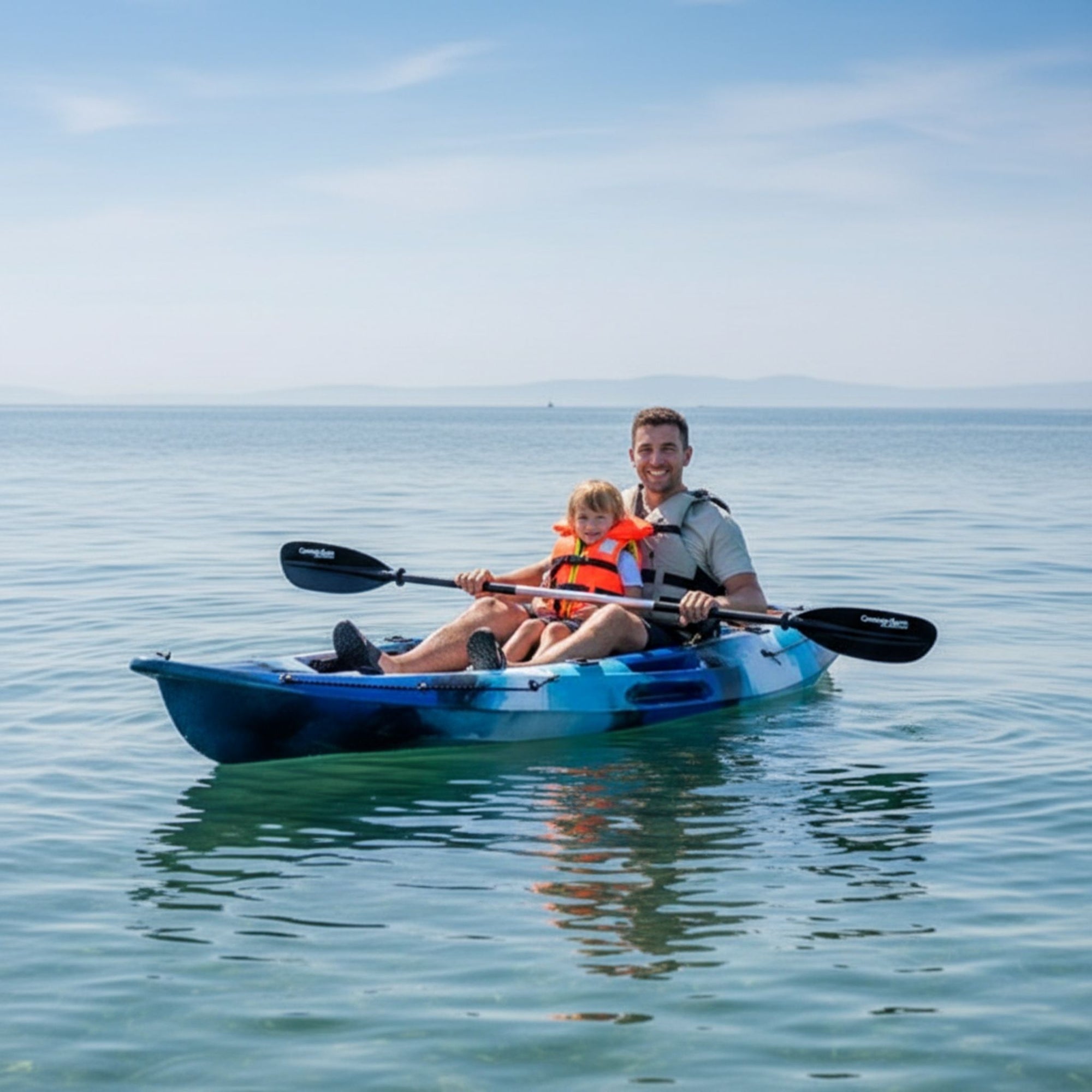 Adult and child using Cambridge Kayaks Quest single 1 plus 1 sit on top kayak on calm sea
