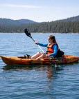 Woman paddling Cambridge Kayaks Quest single 1 plus 1 sit on top kayak on calm lake