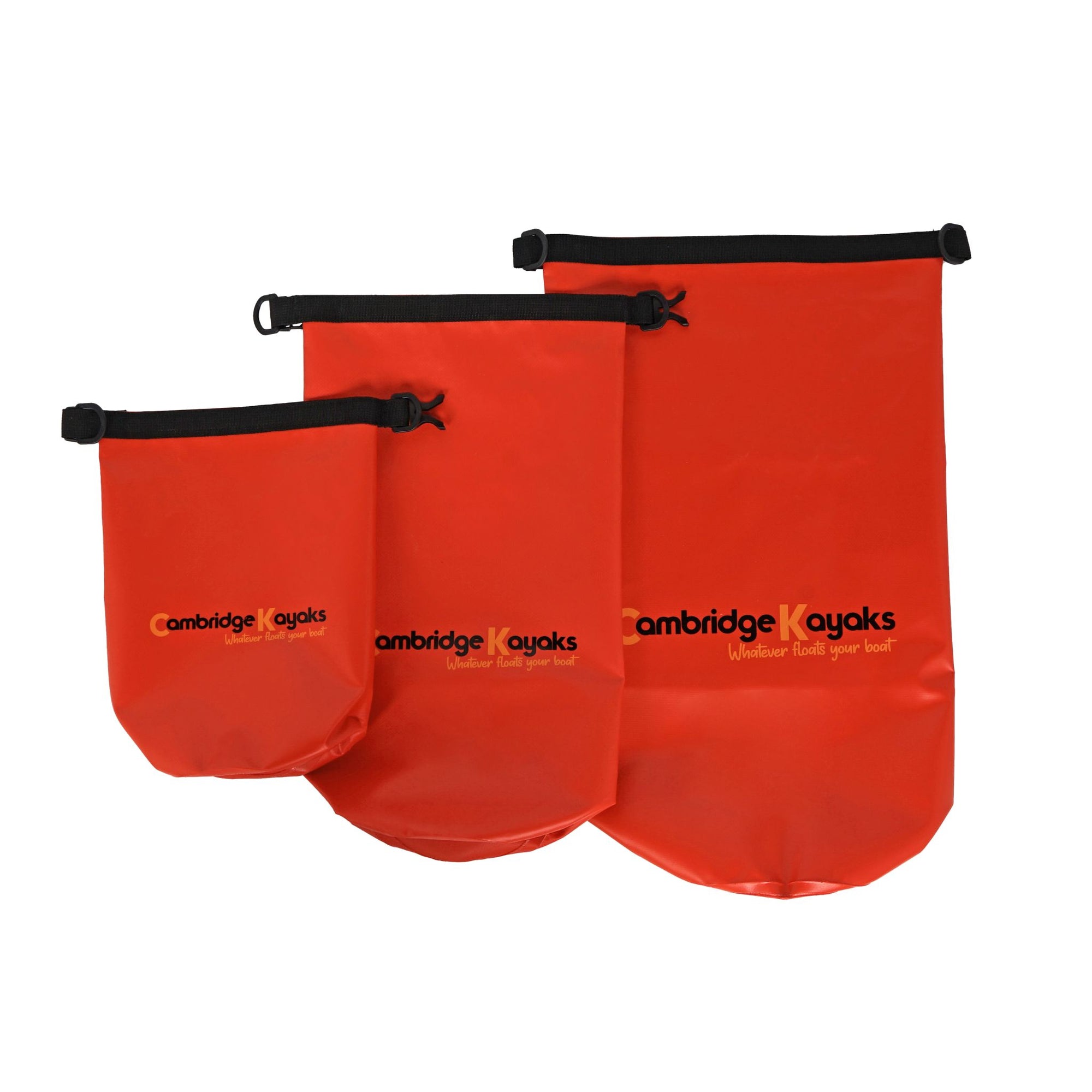 Three red Cambridge Kayaks dry bags displayed together in different sizes to illustrate capacity options. Each bag includes a roll-top closure, buckle clip, and waterproof welded seams — ideal for multi-day kayaking trips or beach outings.