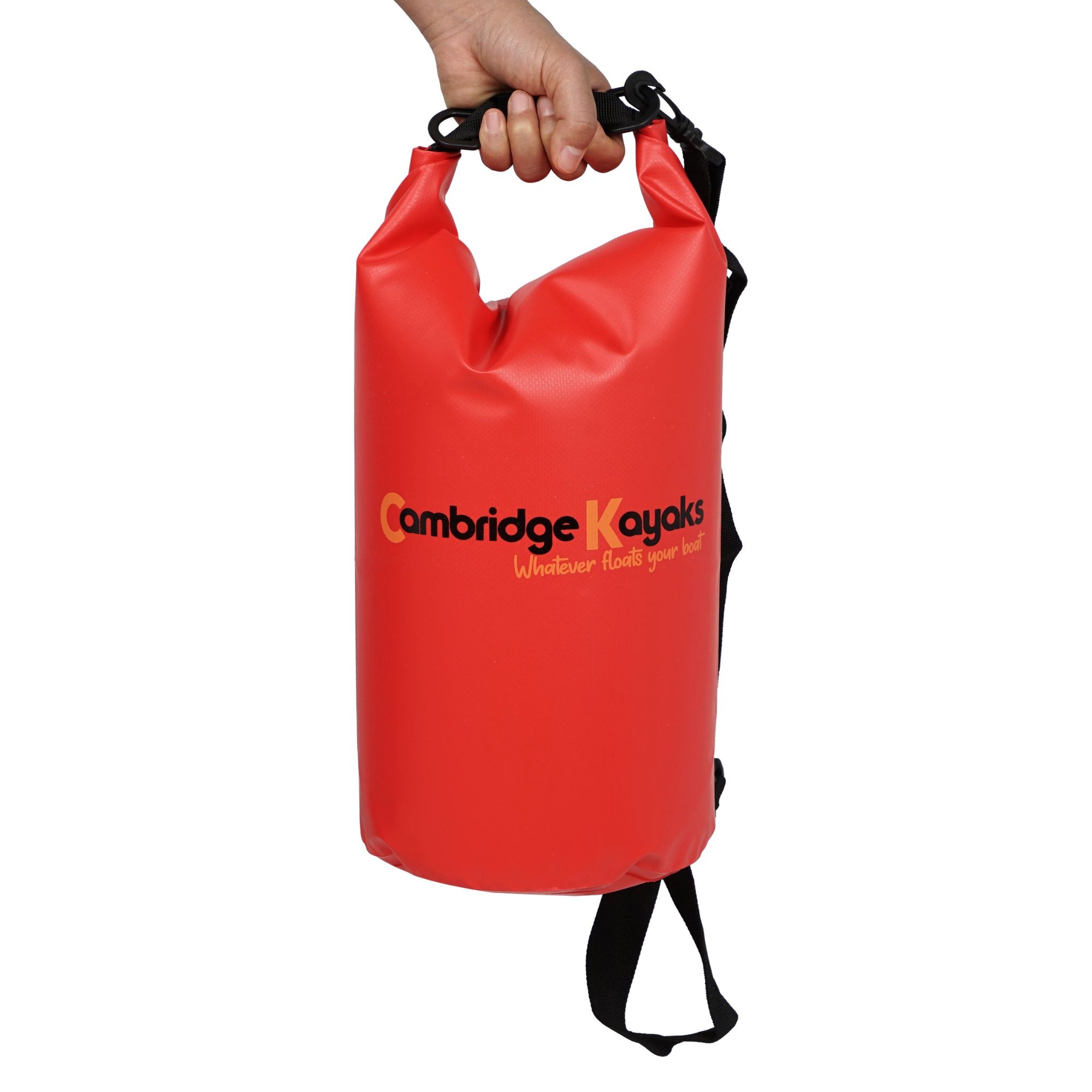 Single red Cambridge Kayaks waterproof dry bag standing upright with shoulder strap attached, designed for portability and outdoor waterproof storage.