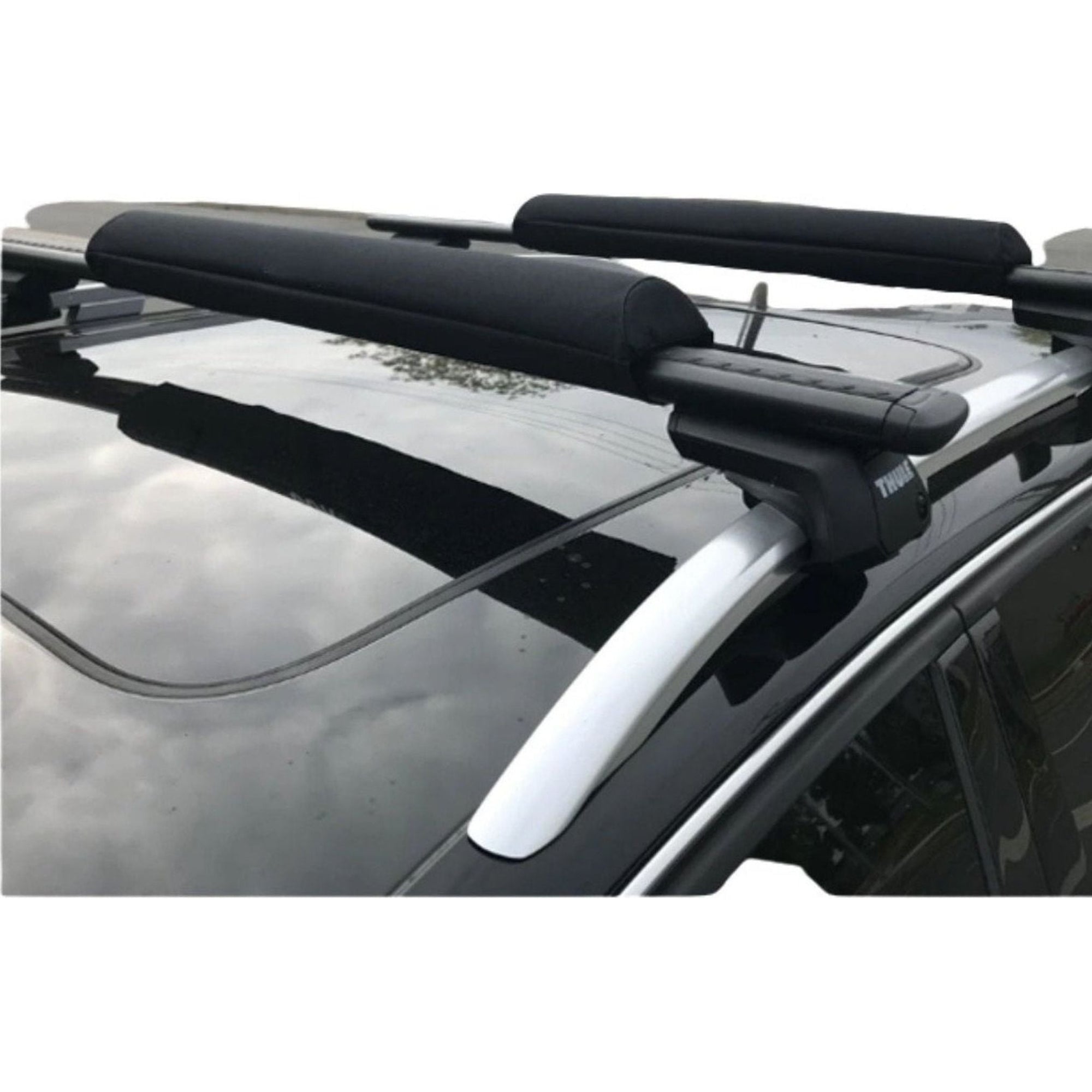 Close-up side view of the Cambridge Kayaks Roof Rack Protector Pads installed on a vehicle’s crossbars, showing thick padded sleeves for secure and scratch-free kayak transport.