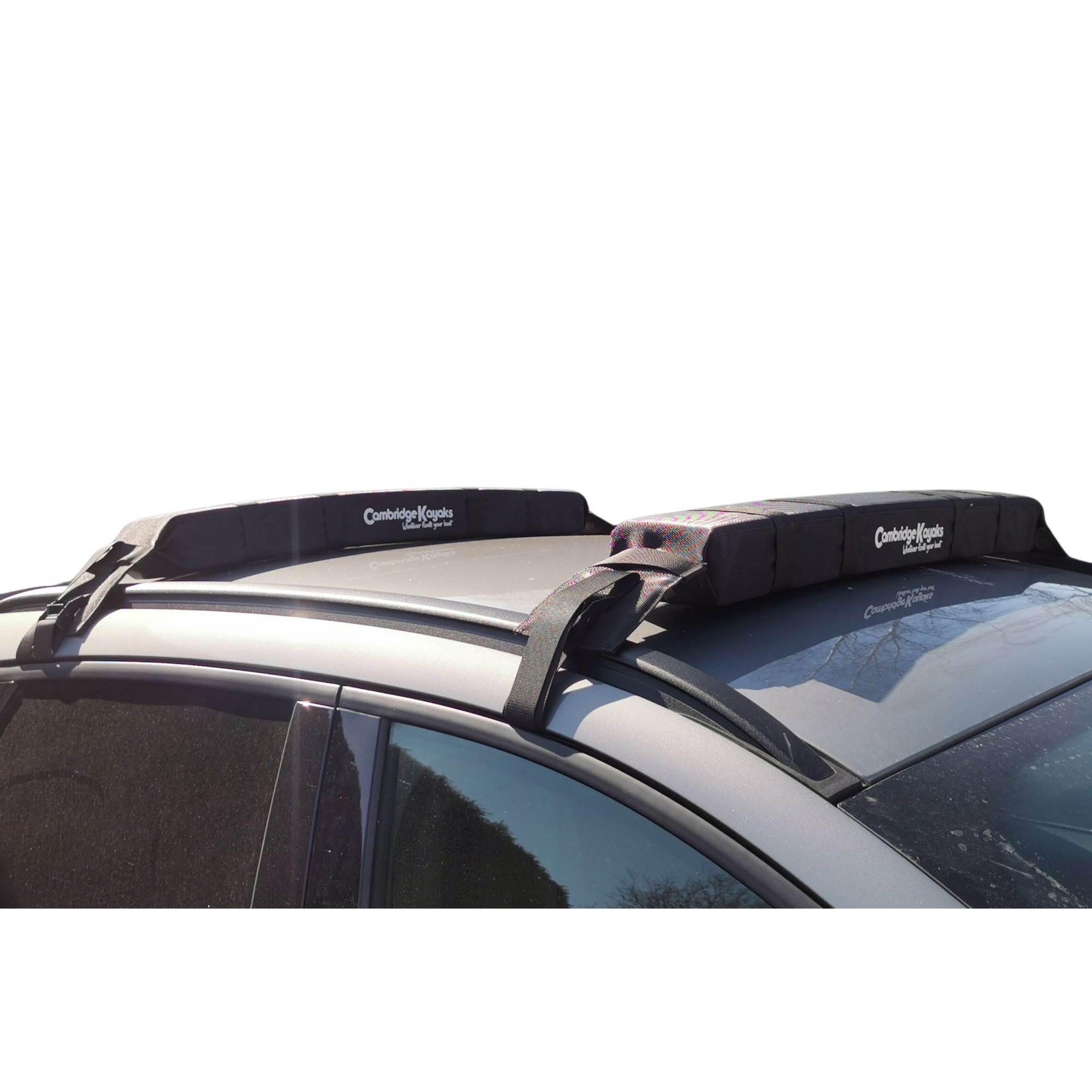 Cambridge Kayaks Soft Roof Rack fitted securely to a vehicle roof, shown from the side to display the cushioned pads and adjustable straps in place. Ideal for carrying kayaks, surfboards, or SUPs safely.
