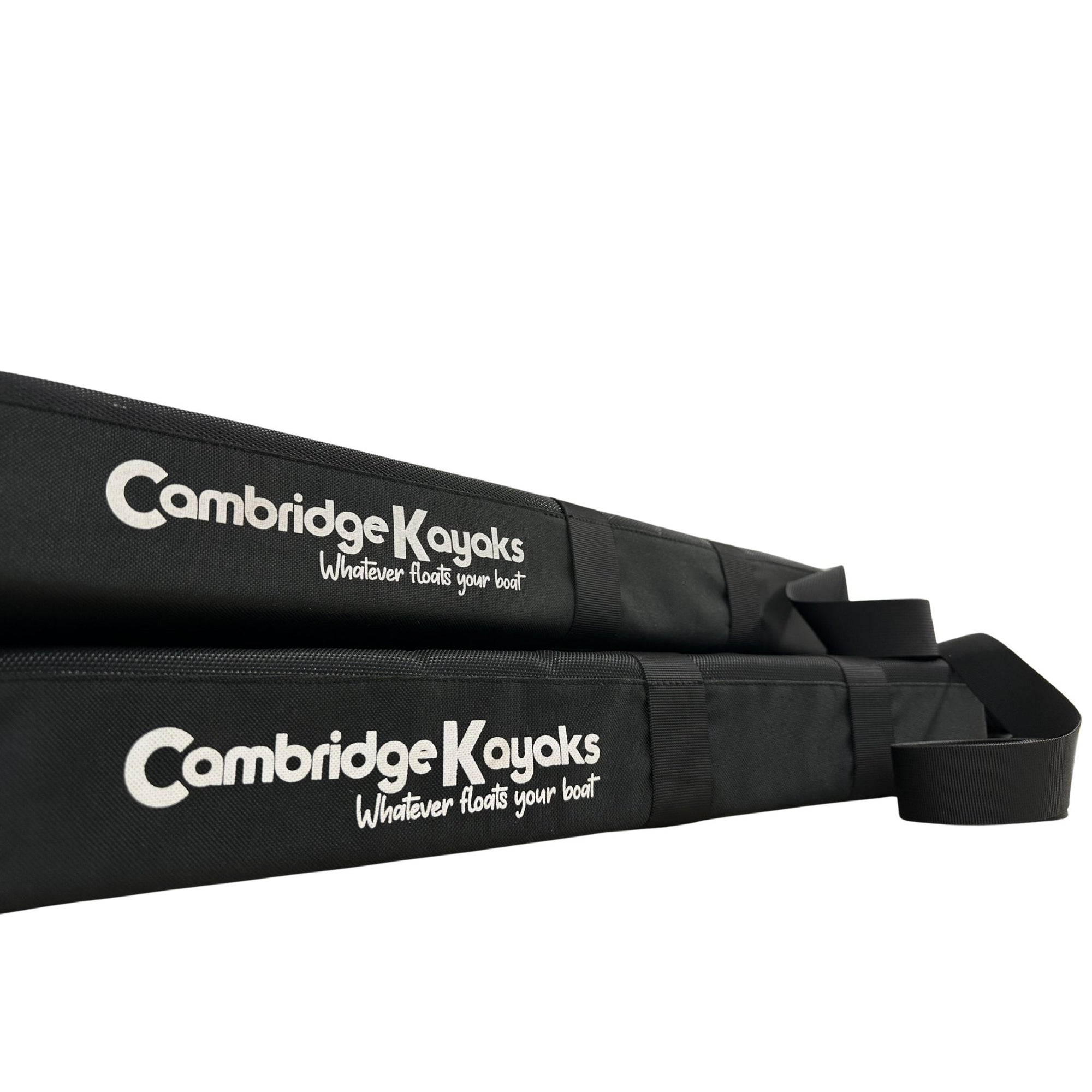 Close-up of two Cambridge Kayaks roof rack pads showing logo and fastening strap details.