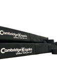 Close-up of two Cambridge Kayaks roof rack pads showing logo and fastening strap details.
