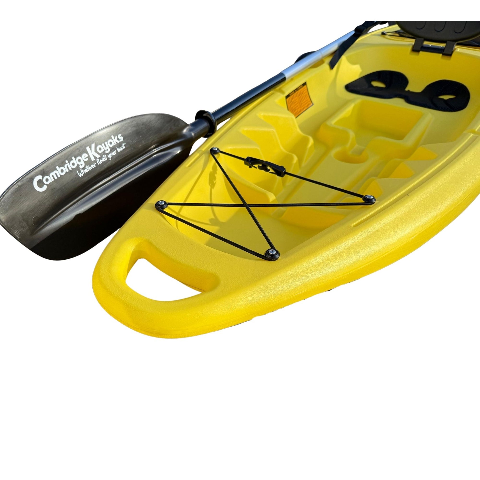 Close-up of the Cambridge Kayaks Trekker junior kayak in bright yellow showing the front bungee storage area, moulded carry handle, and black paddle featuring the Cambridge Kayaks logo, ideal for young paddlers.