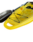 Close-up of the Cambridge Kayaks Trekker junior kayak in bright yellow showing the front bungee storage area, moulded carry handle, and black paddle featuring the Cambridge Kayaks logo, ideal for young paddlers.