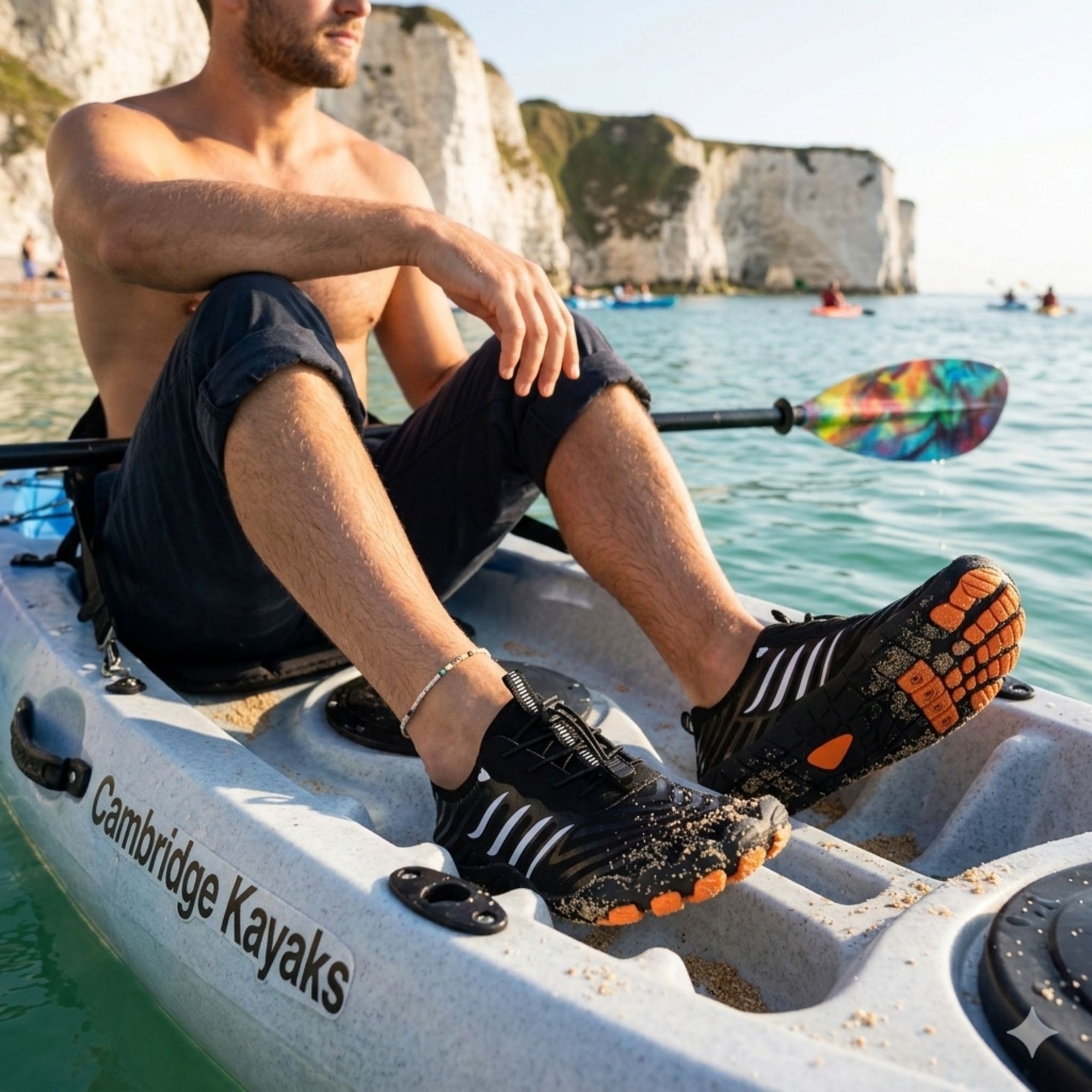 Man wearing water shoes while kayaking showing quick dry material and non slip grip for paddling and water sports