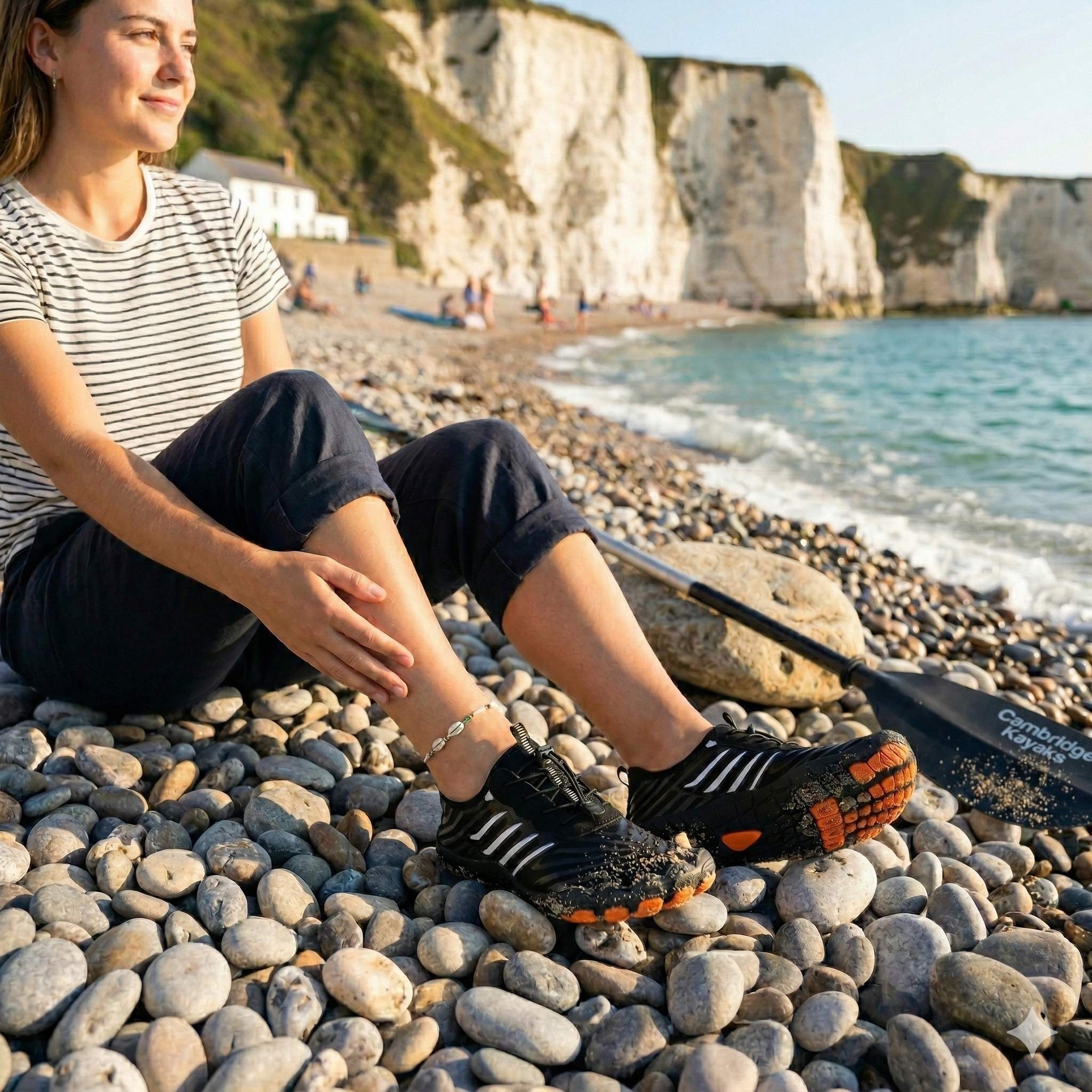 Woman wearing water shoes on pebble beach showing strong grip and non slip sole for coastal walking and water activities