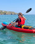 Side view of person kayaking in single sit on top kayak on clear sea
